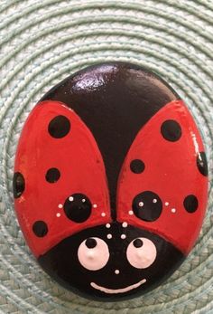 a lady bug painted on top of a rock