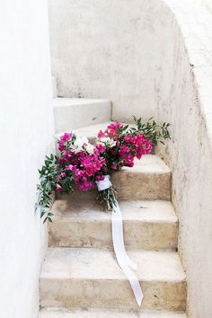 a bouquet of flowers sitting on the steps