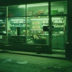 an empty store front at night with the lights on