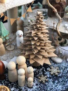 a christmas tree made out of cardboard sitting on top of a table next to other decorations