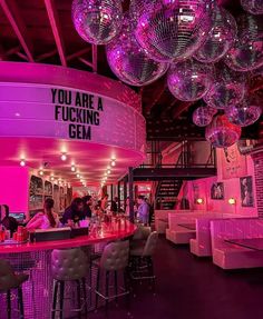 a bar with disco balls hanging from the ceiling