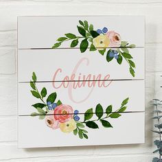 a painted wooden sign with flowers and the word couve written in cursive writing