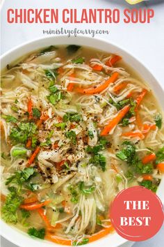 chicken cilantro soup with carrots and broccoli in a white bowl