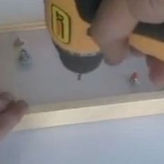 someone is using a tool to fix a hole in the ceiling with screwdrivers