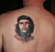 a man with a tattoo on his back that has a portrait of cheechi