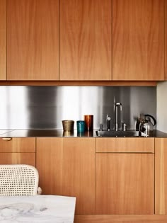 a kitchen with wooden cabinets and stainless steel appliances