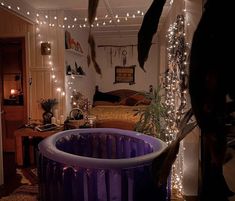 an inflatable bathtub is surrounded by fairy lights