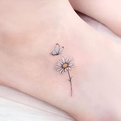 a small daisy and butterfly tattoo on the ankle