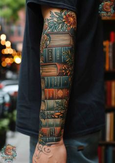 a man's arm with books on it and flowers in the middle, while he is