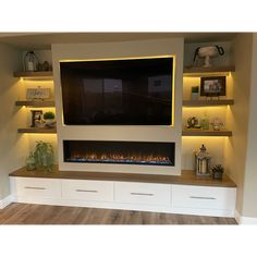 an entertainment center with built - in fireplaces and shelves