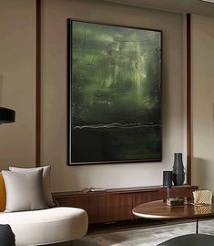 a living room filled with furniture and a painting hanging on the wall above it's coffee table