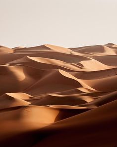 sand dunes in the desert with no one on them or people walking through it,