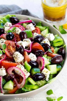 a salad with olives, tomatoes, cucumbers and feta cheese in it