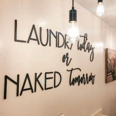 there is a sign that says laundry days or naked tomorrow on the wall in this bathroom