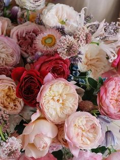 a bunch of flowers that are in the middle of some kind of flower arrangement on a table