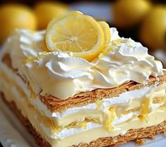 a close up of a piece of cake on a plate with lemons in the background