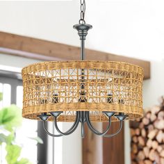 a wicker chandelier hanging from a ceiling in a room with wood logs