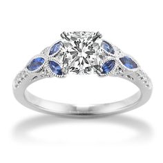 a diamond and blue sapphire engagement ring