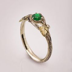 -----> A Video is Available here - https://youtu.be/OLrUkNPnh5E---> A matching band is available here - https://www.etsy.com/il-en/listing/656071340/A delicate, handmade engagement ring made in two gold colors and set with a natural green emerald of high quality.The grooves in the band are plated with black rhodium which emphasizes the texture.If you prefer not to apply the black rhodium that is fine.I can also use white, rose or yellow gold for the band and the leaves for the same price.The rin Green Emerald Ring With Single Cut Diamonds For Promise, Emerald Green Promise Ring With Single Cut Diamonds, Green Promise Rings With Nature-inspired Style, Nature-inspired Green Emerald Ring For Anniversary, Nature-inspired Green Emerald Anniversary Ring, Nature-inspired Green Jewelry For Promise, Emerald Rings With Single Cut Diamonds For Gifts, Green Nature-inspired Promise Rings, Unique Yellow Gold Emerald Promise Ring