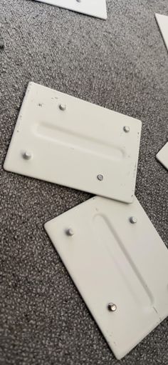 several pieces of white plastic sitting on top of a carpeted floor next to each other