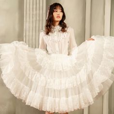 Create a stunning silhouette with our white/black 65cm puffy multi-layered A-line petticoat. This versatile petticoat features multiple layers of tulle fabric, adding volume and flare to any skirt or dress. The A-line shape provides a flattering fit, and the 65cm length is perfect for achieving that classic Lolita or Kawaii look.  Please note that this product includes only the petticoat.  Garment Size   	 		 			Size 			Free Size 		 		 			Full Length 			65 		 		 			Waist 			60-90 Spring Voluminous Tulle Petticoat, Elegant Spring Ruffled Petticoat, Full Petticoat With Ruffles For Party, Spring Tulle Petticoat With Ruffles, Fitted Ruffles Petticoat Balletcore Style, White Tulle Full Skirt Dress, White Tiered Skirt Dress With Layered Details, White Layered Dress With Tiered Skirt, White Tulle Dress With Full Skirt