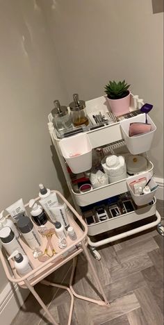 a white shelf filled with lots of beauty products on top of a wooden floor next to a wall