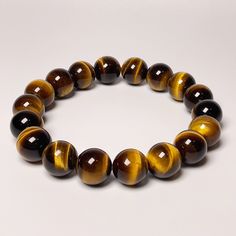 Gemstone: Tiger's Eye Round Bead Size: 10+mm Barrel Bead Size: 10mm x 13mm ITEM # Round Shape: 3281013210 Barrel Shape: 3281013310 WRIST SIZE FOR THE ITEM: Up to 6.25 inches NOTE: - The color of the product may vary slightly in the picture as a result of lighting. Images may not depict the actual product as they are enlarged to show detail. - Because of their nature, mineral specimens can vary slightly in size, color, or shape. They may also have small blemishes, pits, or flaws due to natural processes. Brown Gemstone Beaded Bracelets, Brown Beaded Round Crystal Bracelet, Brown Crystal Bracelet With Gemstone Beads, Brown 8mm Beaded Round Bracelets, Brown Bracelet With 8mm Round Beads, Brown Bracelets With 8mm Beads, Brown Jewelry With 8mm Round Beads, Brown Round Bracelets With 8mm Beads, Brown Beaded Bracelets With Spacer Beads