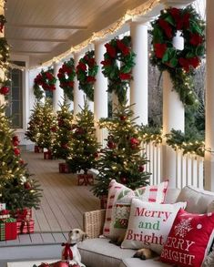 a porch decorated with christmas trees and presents