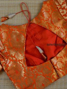 1. Fabric  - Brocade.  2. Boat Neck Blouse.  3. Elbow Sleeves Blouse.  4. Customize in any color and size. Triangle Back Neck Blouse Design, Triangle Blouse Designs, Orange Blouse Designs, Brocade Blouse Designs, Blouse Sari, Blouse Crop Top, Blouse Necklines, Blouse Designs High Neck, Boat Neck Blouse Design