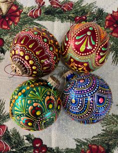 three ornaments are sitting on a table cloth