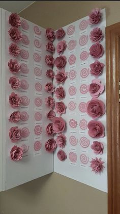 an open book with pink paper flowers on it