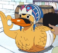 a cartoon duck wearing a pirate hat and sitting on the ground next to a barrel