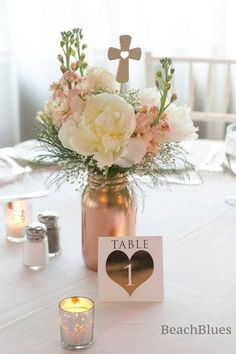 the table is set with flowers and candles for an elegant centerpieces on pinterest