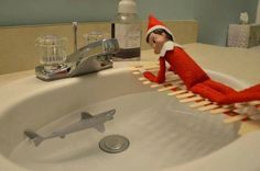 an elf is sitting in the bathroom sink