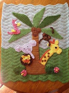 a crocheted tree with animals on it