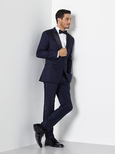 Our midnight blue tuxedo is a daring alternative that conveys both confidence and taste. Don’t worry—blue can be just as formal as black, especially paired with the classic black bowtie.  Our tuxedo pants have waist adjusters up to 2”, but do not have belt loops or suspender buttons. Elegant Wool Suits For Party, Fitted Wool Suits For Party, Fitted Wool Suit For Party, Tailored Wool Suits For Party, Fitted Wool Suits For Evening, Fitted Wool Suit For Evening, Formal Blue Wool Tuxedo, Evening Wool Suits With Notch Lapel, Wool Suits With Notch Lapel For Evening