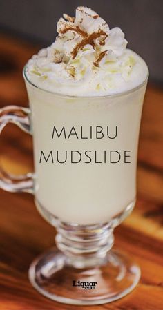 a close up of a drink in a glass on a table with the words malbu mudslide