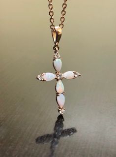 DeKara Designs Collection Metal- 14K Rose Gold .585 Stone- 5 Genuine Australian Pear Shape Opals, 5 Round Diamonds G Color VS2 Clarity 0.15 Carats. Necklace- 14K Rose Gold 18 Inch Necklace. Measurements- 1.05 Inches Long. Art Deco Influenced Beautiful Opal Diamond Cross Made In 14K Rose Gold. There are five pear shape opals that are prong set. There are five prong set diamonds on the cross as well, with four of them on top of the opals and one in the center. This is a beautiful piece that is ent 14k Pink Gold Necklace For Wedding, 14k Pink Gold Necklaces For Wedding, Pink Gold 14k Gold Necklace For Wedding, Pink Gold 14k Wedding Necklace, White 14k Gold Cross Jewelry, 14k Gold Cross Jewelry In White, Spiritual Oval Rose Gold Jewelry, Luxury 14k Rose Gold Jewelry, Rose Gold Cross Pendant For Formal Occasions