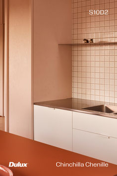 a kitchen with white cabinets and brown counter tops