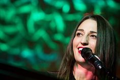 a woman that is standing up with a microphone