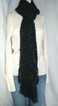 I crocheted this oversize Black Scarf. This Goth scarf is soft and warm, a mans, teens or womans wrap. I handmade this using a loose knit crochet stitch to about 100 inches long x 5 inches wide with fringe on both ends. Thats over 8 feet long. This is a chunky yarn scarf, very Gothic. A Sherlock Holmes or Doctor Who type scarf. The yarn I used for this scarf is an acrylic, polyester blend. It is elegant and stunningly gorgeous. This would made a stylish gift, perfect for a birthday present.  Long enough for even the tallest person. You can wrap this scarf around and around your neck to make a cowl. C1005 These handmade scarves I make with loose knit crochet stitches will sometimes shrink or stretch out. The measurements are taken when newly made before I pack them into inventory storage. Chunky Yarn Scarf, Knit Crochet Stitch, Women Anime Cosplay, Crocheted Scarves, Scarf Chunky, Scarf Yarn, Handmade Scarves, Black Scarf, Chunky Yarn