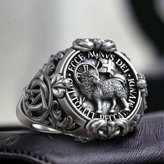 Celebrate the profound symbolism of faith with our Lamb of God Agnus Dei Christian Jesus Christ Ring, crafted from high-quality 925 sterling silver. This exquisite ring features a detailed depiction of the Lamb of God, symbolizing Jesus Christ as the sacrificial lamb who takes away the sins of the world. The Agnus Dei motif is intricately designed, representing purity, redemption, and divine love. Perfect for those who appreciate meaningful and religious jewelry, this adjustable ring ensures a c Silver Jewelry With Engraved Logo For Gift, Silver Jewelry With Engraved Logo, Silver Round Jewelry With Engraved Logo, Masonic Ring, Viking Ring, Retro Ring, Animal Rings, Gifts For Brother, Handmade Rings