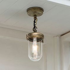 an old fashioned light fixture hanging from the ceiling