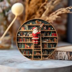 a clock with a santa clause on it sitting next to a book shelf filled with books