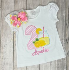 Lemonade Birthday Shirt and Hairbow, 2nd Birthday Gift Girl Shirt, ANY Size, ANY Age, Lemon Jar Birthday Shirt Embroidered Lemonade themed Puffed Sleeve Shirt! It can be made on a bodysuit or a T-shirt. I can customize the shirt with ages 0-3M to Size 12 Shirts are made to order and the design is embroidered by me in my studio using commercial grade professional embroidery machines to ensure best quality for your special shirt.   Machine Wash COLD & HANG DRY. HOW TO ORDER!! 1. Choose size 2. Click add to cart 3. Include the AGE and NAME to the PERSONALIZATION SECTION 4. Proceed to Checkout ** Please include AGE and NAME in the NOTES TO PERSONALIZATION SECTION during the checkout process** Yellow Tops For Summer Birthday, Birthday Elf, Lemonade Birthday, Lemon Shirt, Jojo Siwa Birthday, 2nd Birthday Gifts, Elf Costume, Custom Design Shirts, Birthday Party Shirt