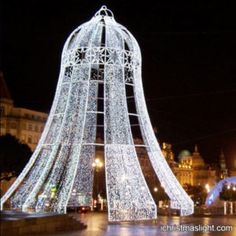 a large structure with lights on it in the middle of a street