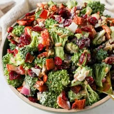 a bowl filled with broccoli and cranberry salad