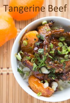 a bowl filled with meat and vegetables next to an orange