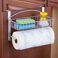 a kitchen cabinet door is open and has a roll of toilet paper in it