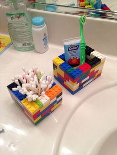 two lego toothbrush holders on a bathroom sink